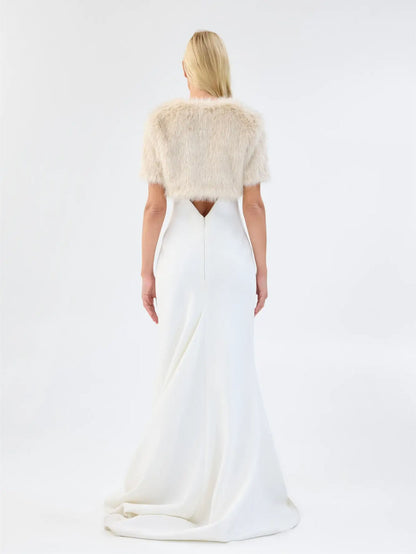 Back view of Unreal Fur Wings Bolero in caramel showing the cropped faux fur silhouette, short sleeves and soft textured finish. 
