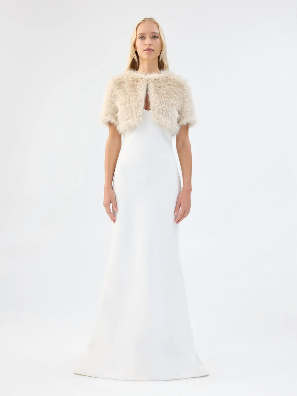 Front view of Unreal Fur Wings Bolero in caramel showing the cropped open-front silhouette, short sleeves and plush faux fur texture. 
