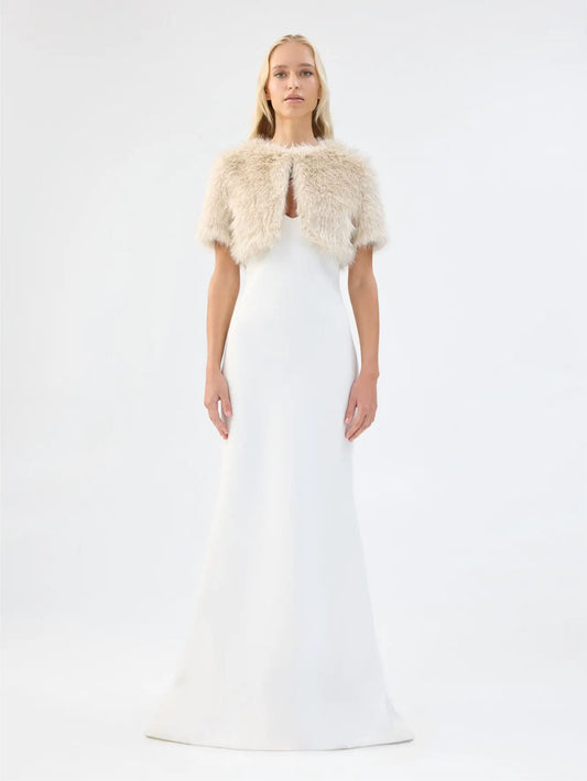 Front view of Unreal Fur Wings Bolero in caramel showing the cropped open-front silhouette, short sleeves and plush faux fur texture. 

