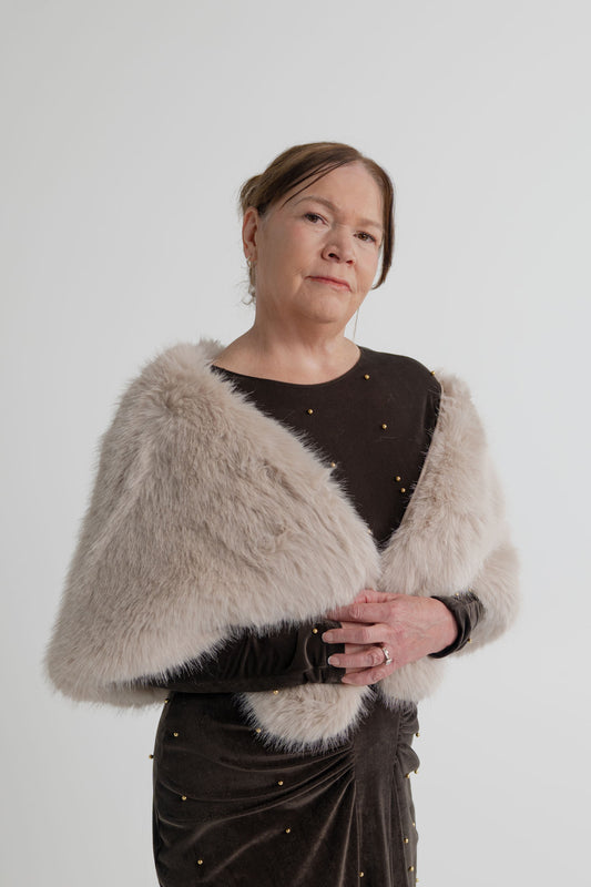 Unreal Fur Yasmine almond faux fur wrap draped over the One Fell Swoop Lucent Iron Maiden dark bronze maxi dress.
