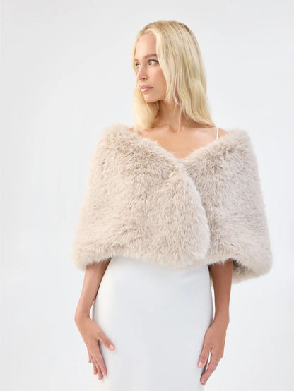 Close-up of Unreal Fur Yasmine Wrap in almond faux fur showing the soft texture and draped shoulder fit. 
