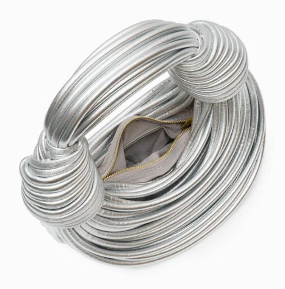 Open view of Verano Hill Amanda silver ribbed bag showing the zippered interior compartment. 
