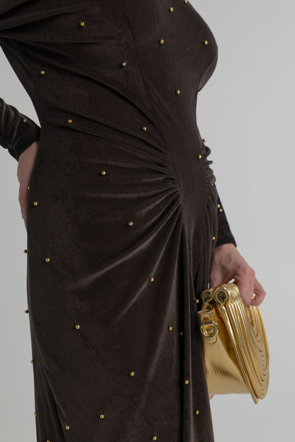 Verano Hill Amara gold metallic handbag styled with the dark bronze velour and gold pearl detailing of the One Fell Swoop Lucent Iron Maiden maxi dress.
