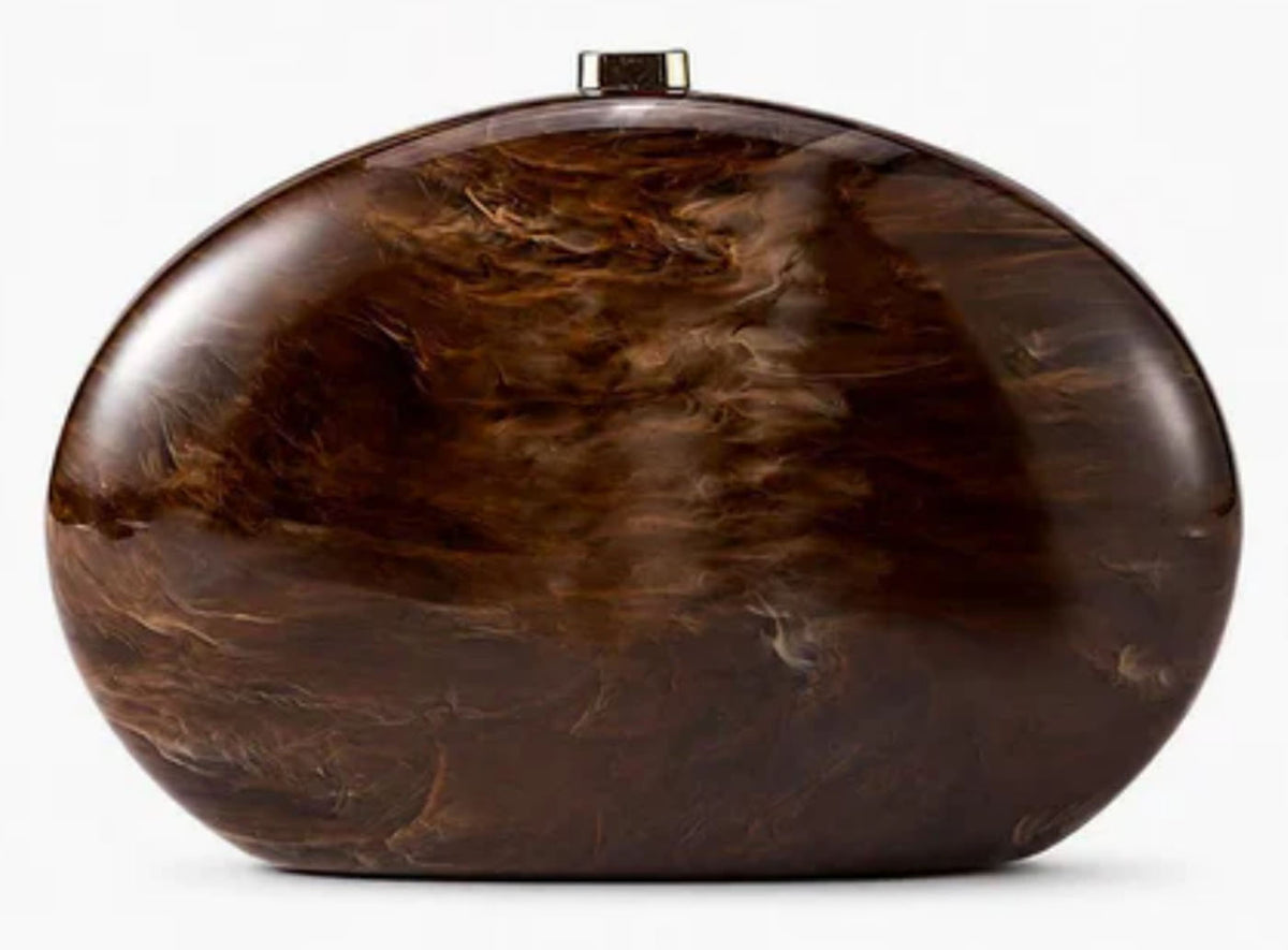 Verano Hill Amber brown marbled clutch with rounded oval silhouette, front view. 
