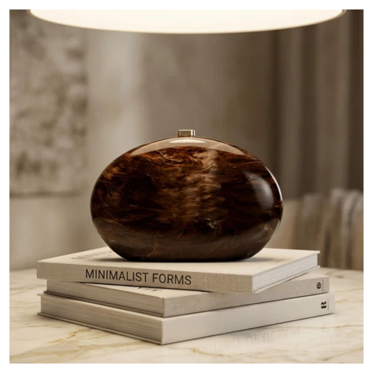 Verano Hill Amber brown marbled clutch with glossy resin finish, styled on stacked books. 

