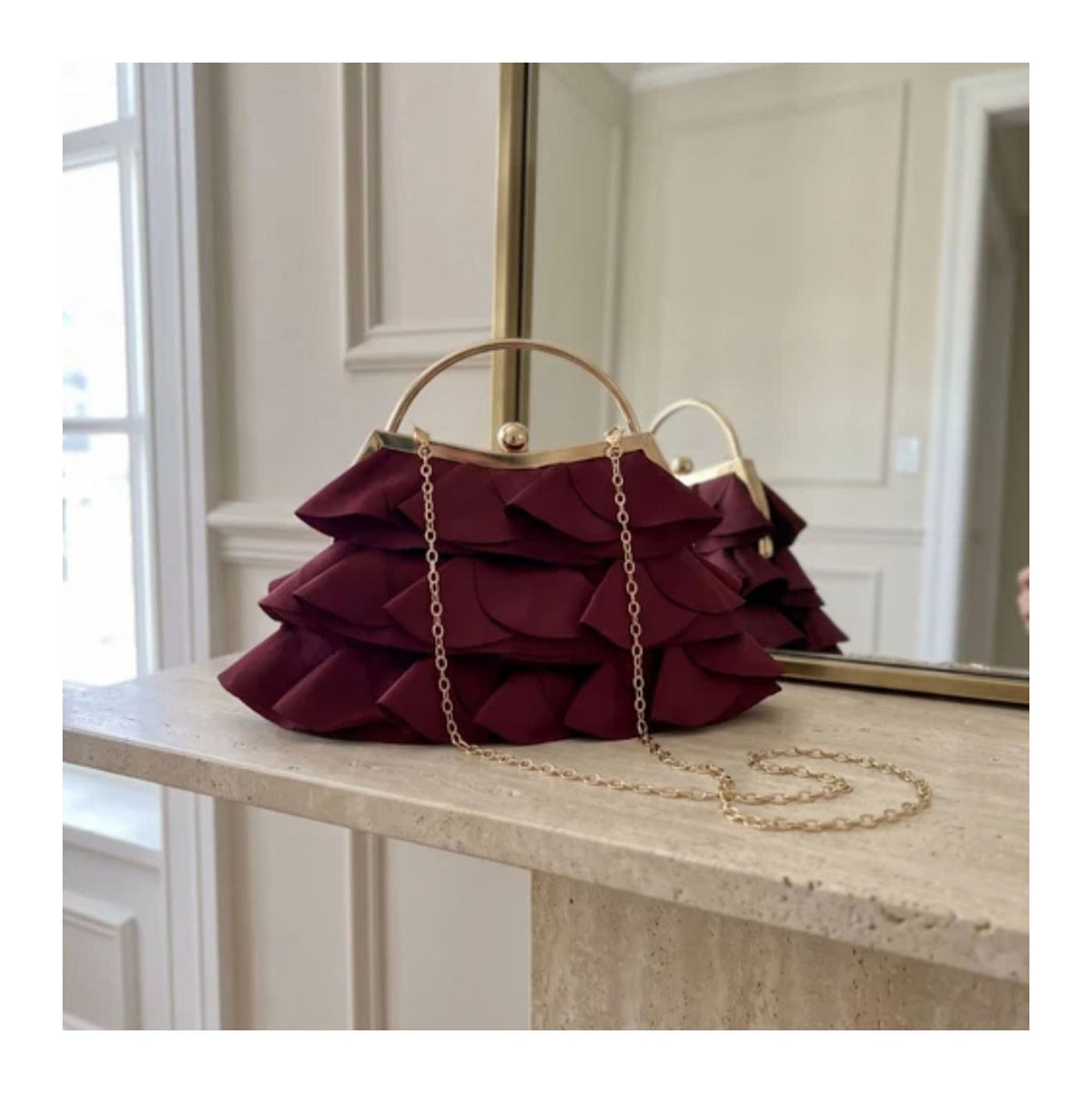 Verano Hill Colette burgundy ruffle bag with detachable gold-tone chain strap. 
