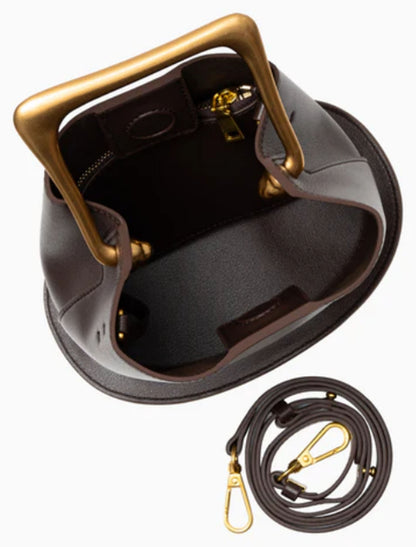 Open view of Verano Hill Vienna dark brown handbag showing the interior compartment, gold-tone hardware and detachable strap. 
