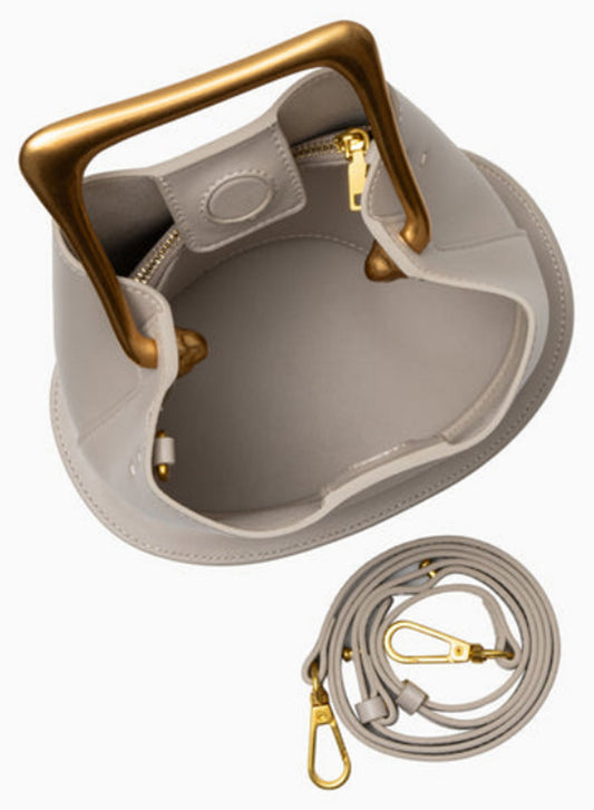 Open view of Verano Hill Vienna greige handbag showing the interior compartment, gold-tone hardware and detachable strap. 
